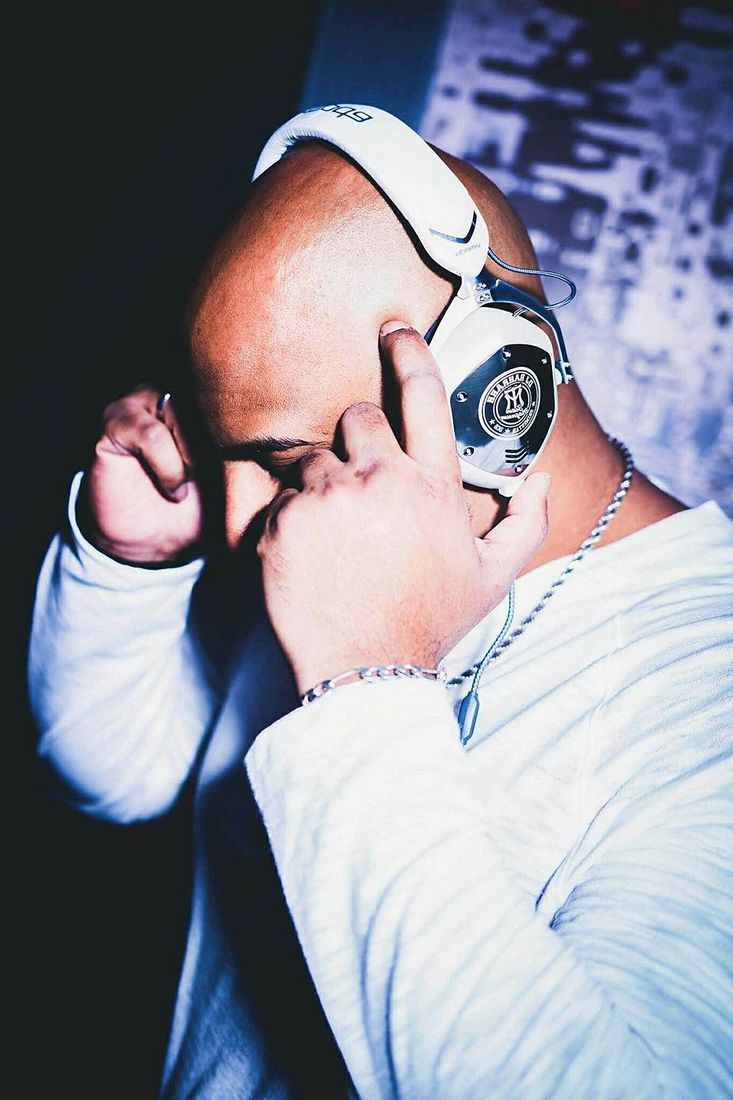 DJ RAH RAHH cueing a record in branded V-MODA headphones