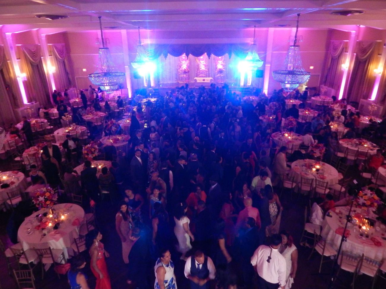 Wide view of a ballroom reception in full swing
