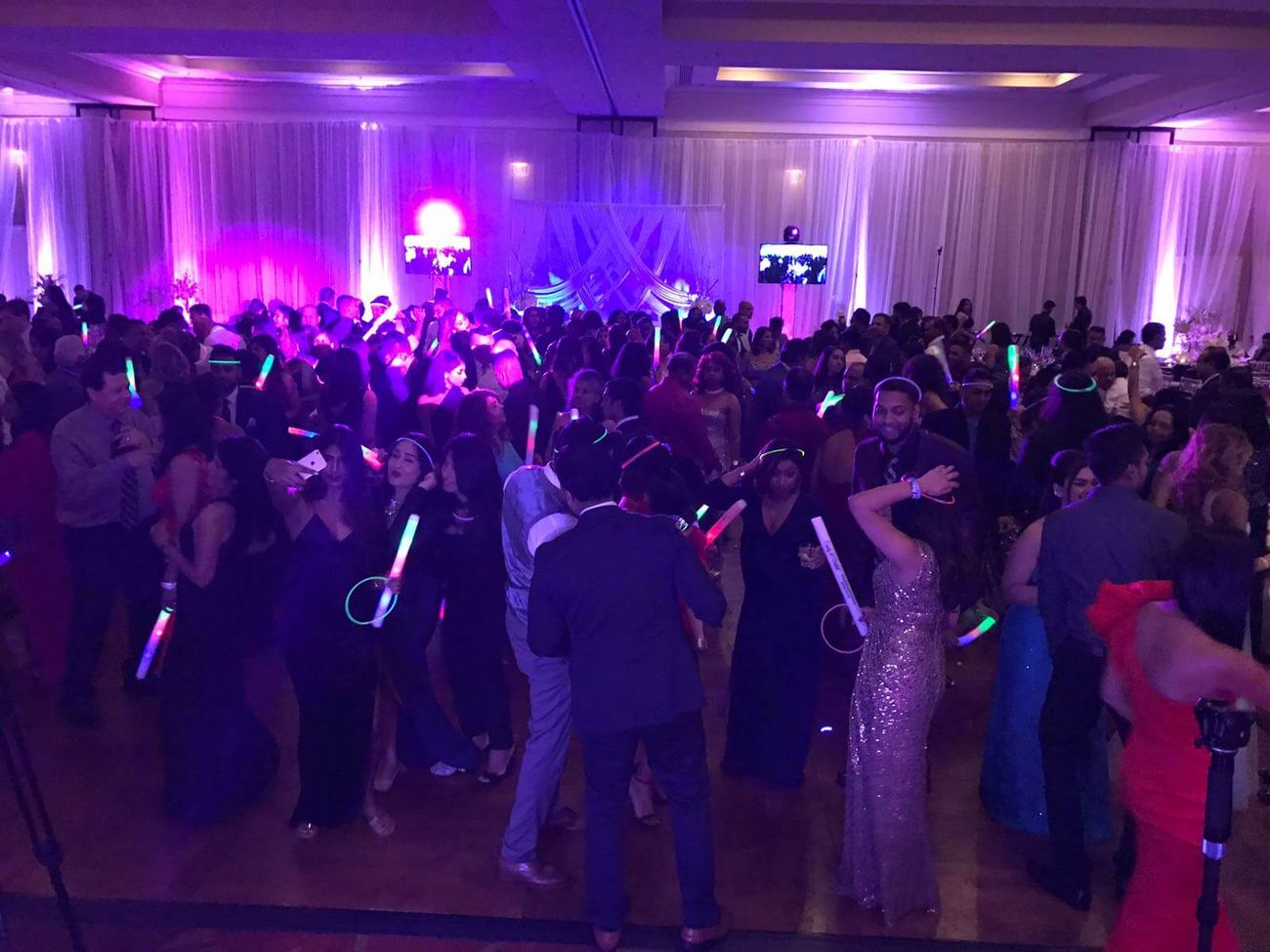 Full dance floor under purple lighting