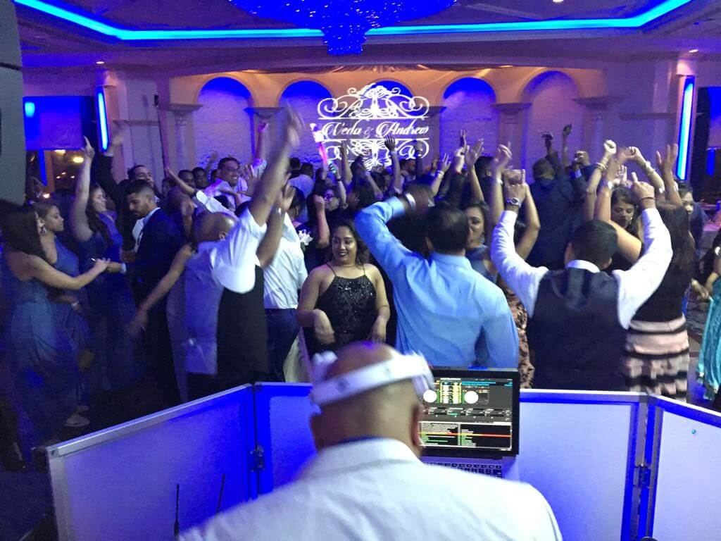 Packed dance floor with hands in the air
